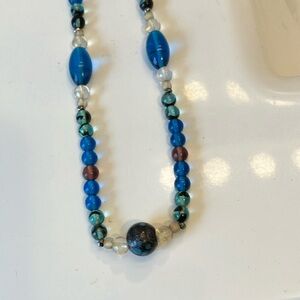 Colored, clear and glass with color in it eyeglass chain with silver accents.